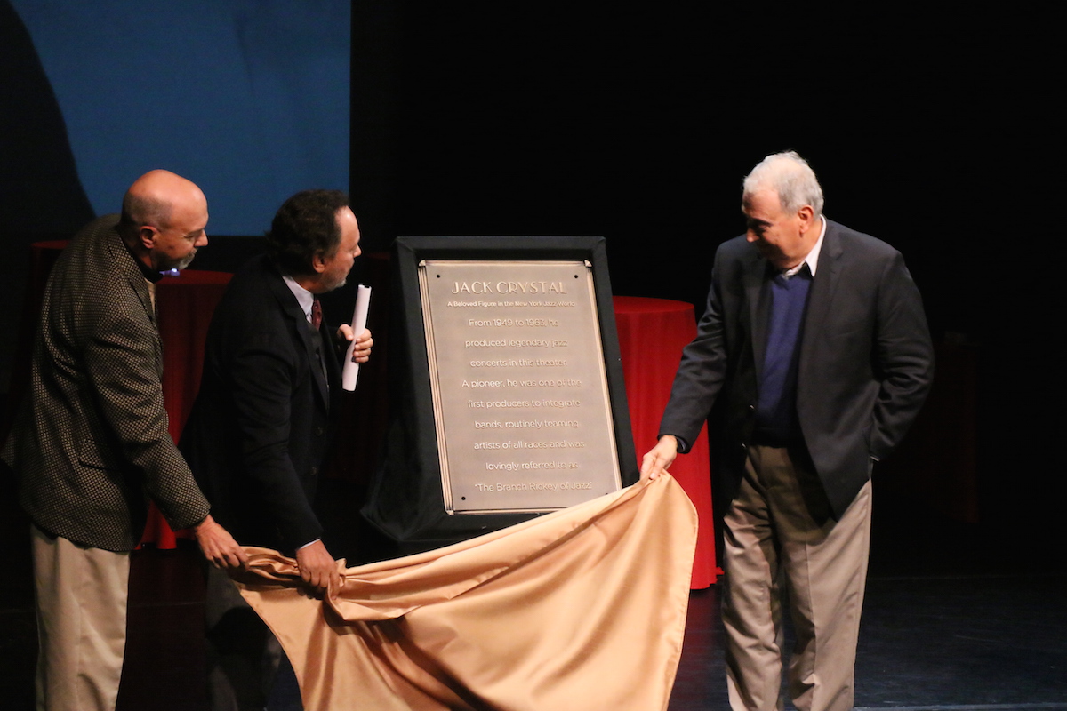 Rip Crystal, Billy Crystal, and Joel Crystal unveil the plaque commemorating their dad, Jack Crystal